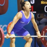 India's weightlifter Saikhom Mirabai Chanu attempts a lift during the Women's 49 Kg weightlifting match