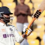 Ravindra Jadeja raises his bat to celebrate scoring a half century during the second day of the first cricket test match between India and Australia
