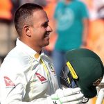 Australia's Usman Khawaja raises his bat to celebrate scoring a century during the first day of the fourth cricket test match between India and Australia