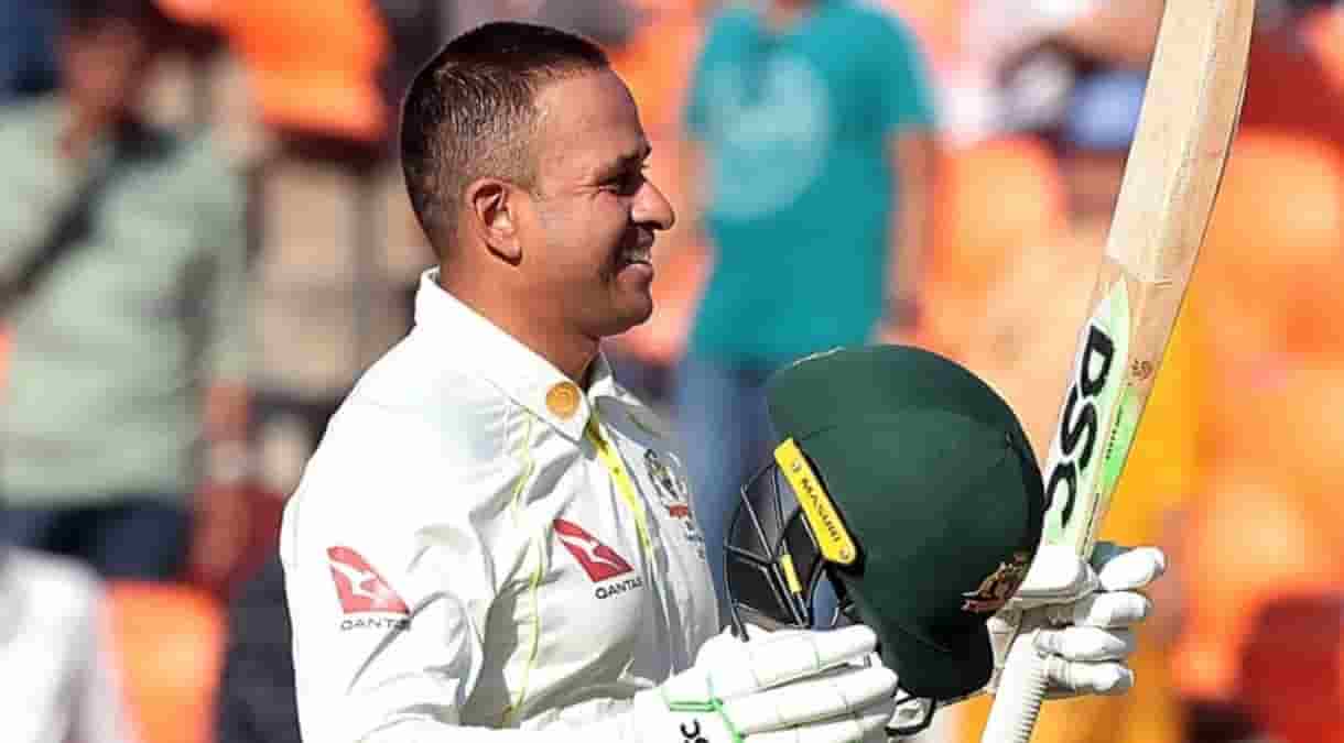 Australia's Usman Khawaja raises his bat to celebrate scoring a century during the first day of the fourth cricket test match between India and Australia