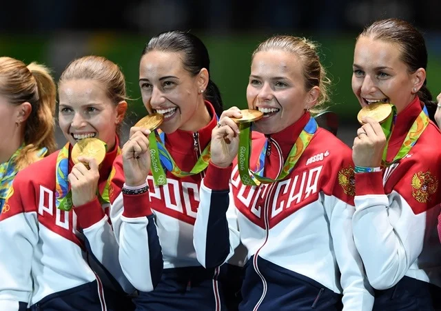 From Currency To Ritual: The History Of The Olympic Medal Bite
